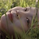 Young Asian Woman Lying on the Meadow with Wind Blowing in Winter Day - VideoHive Item for Sale