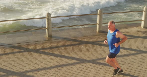 Senior man running on the promenade