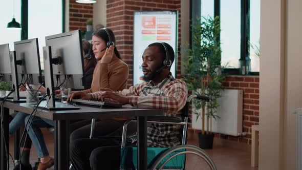 African American Man in Wheelchair Answering Helpline Call