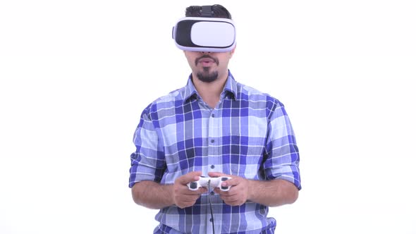 Bearded Persian Hipster Man Playing Games and Using Virtual Reality Headset