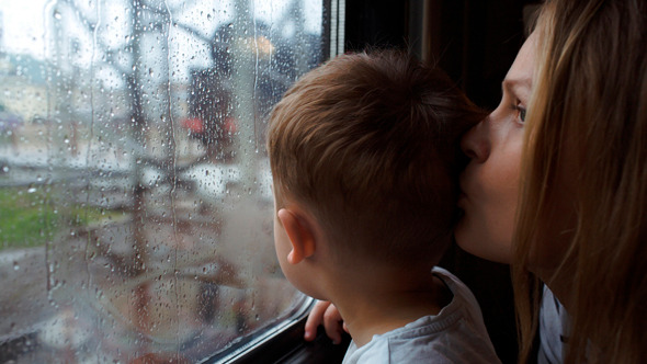 Boy And His Mother Looking Out The Window Of Train