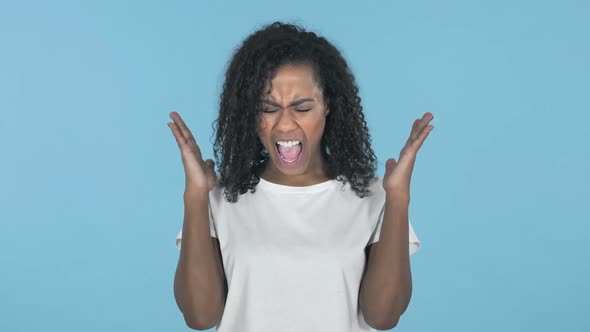 Screaming Angry African Girl Isolated on Blue Background