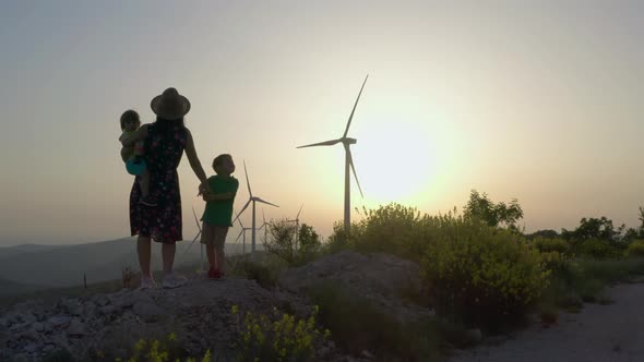 The Aerial View Family Goes to Windmills That Generate Electricity at Sunset