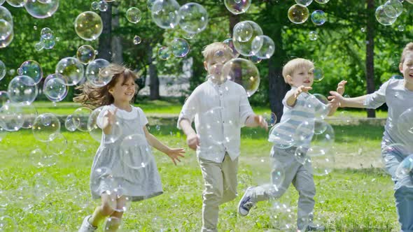 Happy Children Running through Lots of Soap Bubbles alt