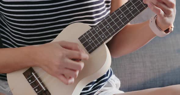 Woman Play Ukulele at Home