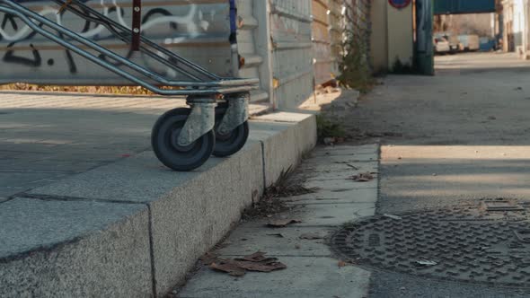 Homeless Man Out on the Streets with His Belongings in a Trolley