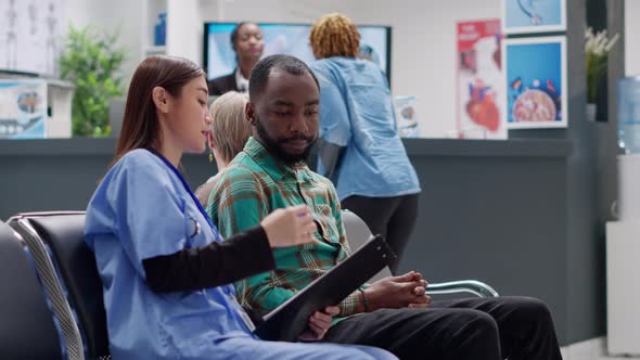 Diverse People Talking About Disease Diagnosis in Waiting Room