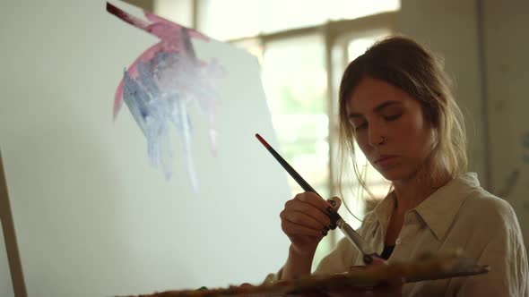 Creative Woman Applying Paint on Canvas