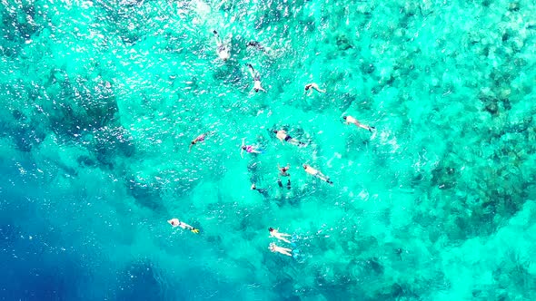 Wide birds eye abstract shot of a white paradise beach and blue sea background in colorful 4K