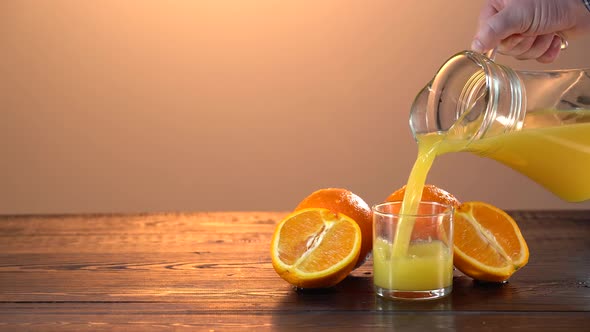 Pouring Fresh Orange Juice Into Glass