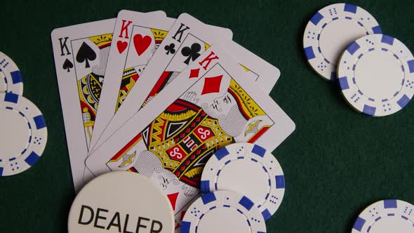 Rotating shot of poker cards and poker chips on a green felt surface - POKER 014