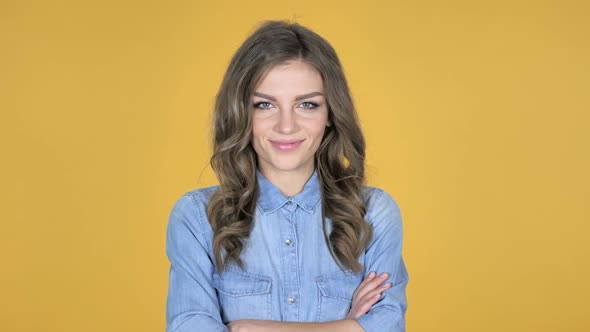 Smiling Young Girl Isolated on Yellow Background