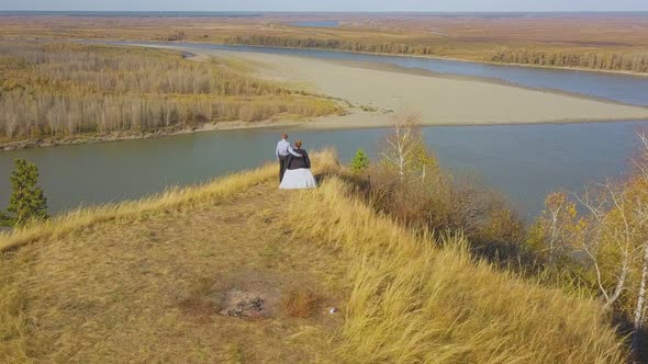 Just Married Couple Enjoys River View From Hill Aerial View