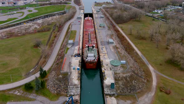 4K aerial footage of a cargo ship at the Beauharnois Canal in the St Lawrence Seaway, Canada.