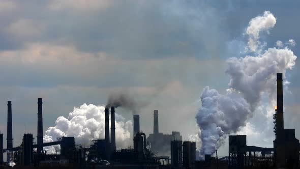 Fuming chimneys.Steam cloud. Processing of minerals. Air pollution concept.