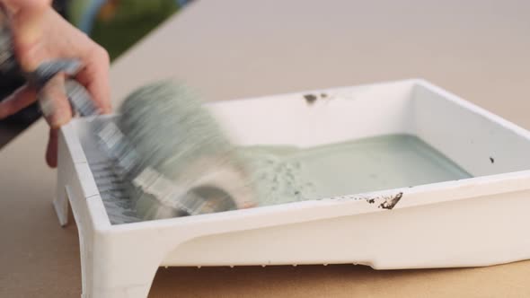 Man Using Paint Roller In Painting Tray