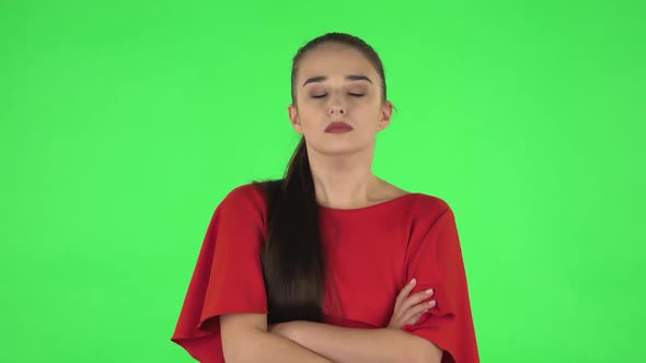 Portrait of Pretty Young Woman Is Listening To Boring Information. Green Screen