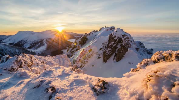 Colorful Golden Sunset in Snowy Alpine Mountains Nature in Winter above Mist Clouds