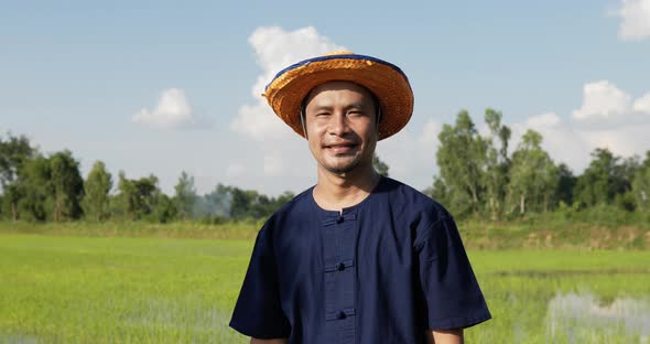 Portrait farmer male standing and arms folded in rice field