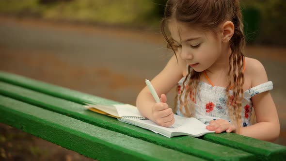 Kid Girl Enjoying Creative Art. Preschool Child Learning Drawing Picture. Child Painting With Pencil