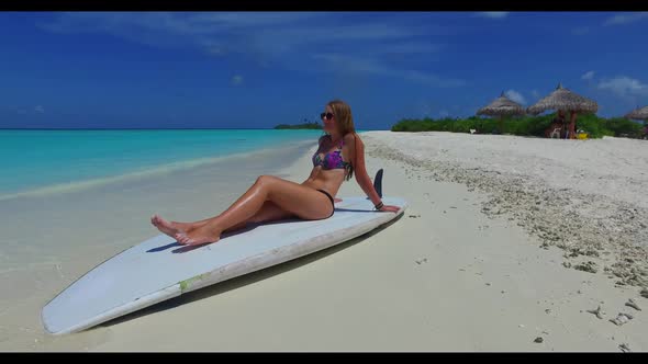 Girls sunbathing on perfect seashore beach vacation by transparent lagoon with white sand background