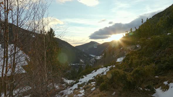 Timelapse of the cloudy sunset in Andorra, the sun hides behind the Pyrenees mountains. 4K