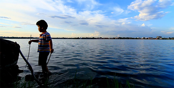 Boy And Lake In Summer Weekend