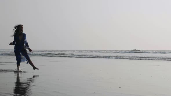 Young Woman Performing Grand Jete Jump on the Beach in Slow Motion