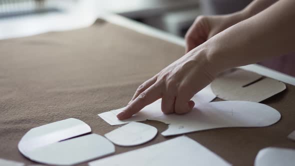 Female Dressmaker Uses Chalk on the Pattern Contour on Textile in Atelier