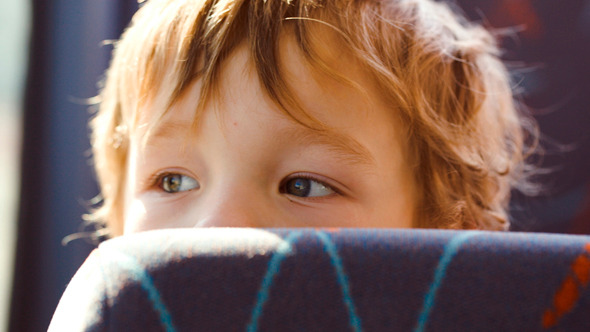Little Boy Behind The Seat In The Bus