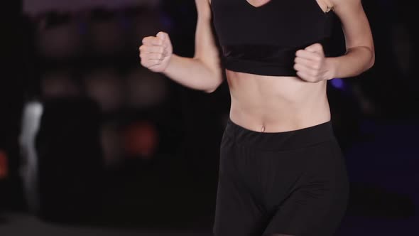 Young Woman Exercising at Gym