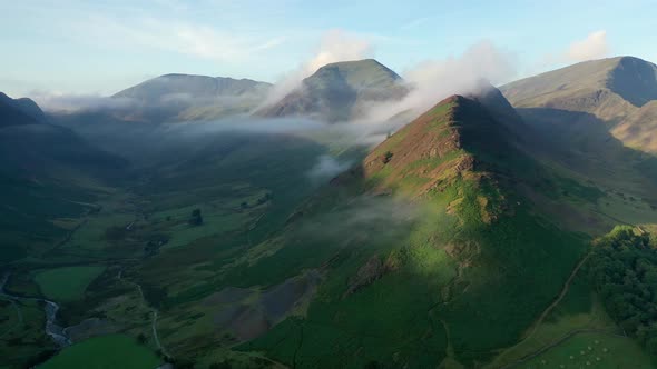 Aerial fly through the Honister Pass in the Lake District, Cumbria with mist.