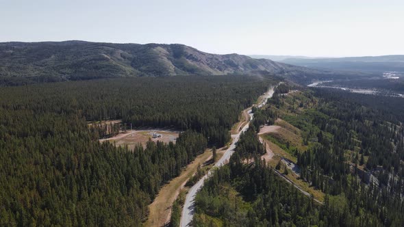 A long dusty logging road leading through boreal forests in the outskirts of the Rocky Mountains. Ae