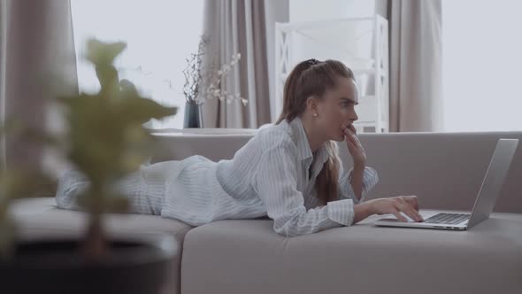 A Young Beautiful Woman Getting Scared and Terrified By Content Found on the Internet Using a Laptop