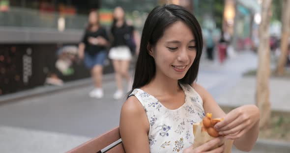 Woman eating Hong Kong famous snack, egg puff