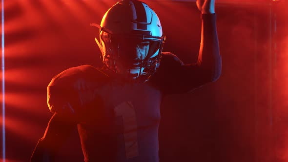 Determined Athlete in Uniforms and Helmet Ready to Play American Football