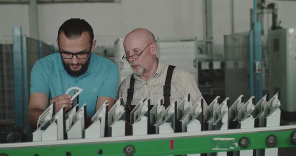 The Manager and Engineer Measure the Plastic Window Frame Using a Calipers