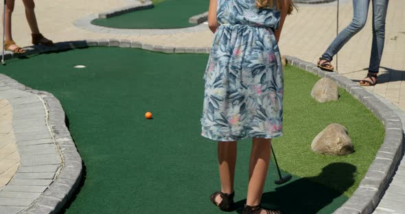 Kids playing miniature golf in the garden