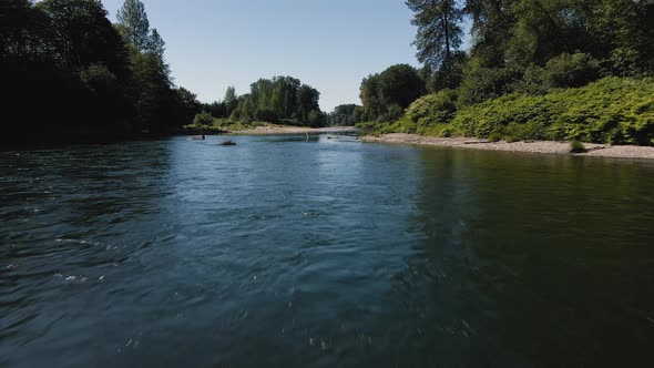 Fast Drone Flying Low Over River Water Surface With Vibrant Natural Environment Colors