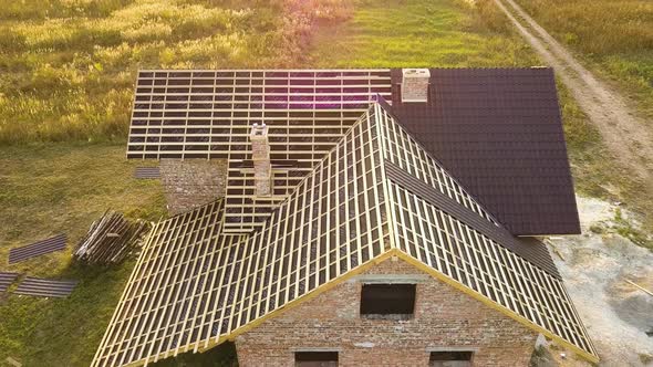 Aerial View of Unfinished House with Wooden Roof Structure Covered with Metal Tile Sheets Under