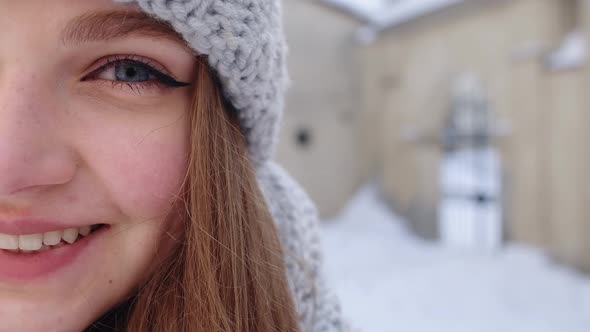 Closeup of Cheerful Positive Young Woman Face Smiling to Camera While Standing Outdoors in Winter