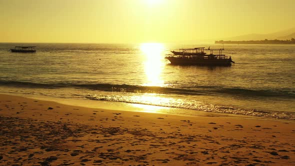 Tropical birds eye tourism shot of a white sand paradise beach and aqua blue water background in bes