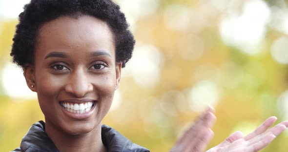 Portrait of Afro American Girl Outdoors Looking at Camera Smiling Toothy Applauding Claps Her Hands