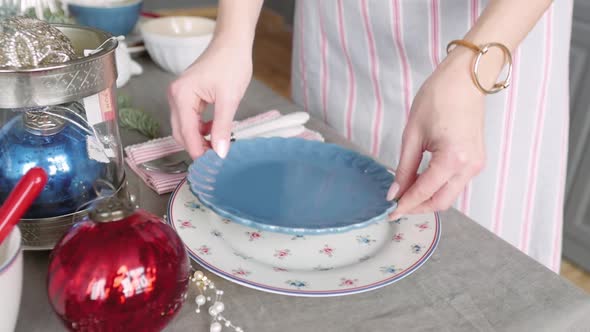 Christmas Table Decoration. Festive Table Setting. Female Hands Decorate the Table for Christmas