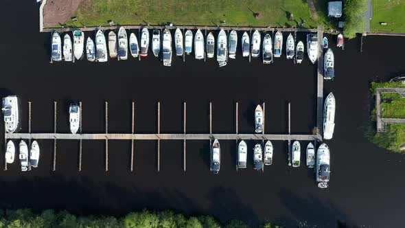 Rows Of Sailboats Docked In The Polder In Waterstaete Ossenzijl, Netherlands. - Drone Overhead Shot