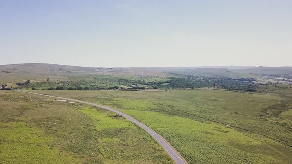 Panorama view of road cutting through Dartmoor National Park in England.