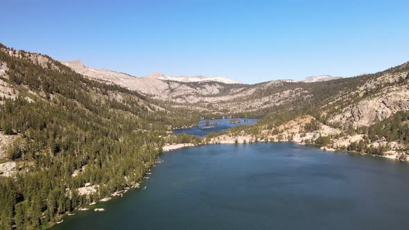 Wind dances on the water of lower Echo Lake in Tahoe as the drone fly's west towards mountains. 2021