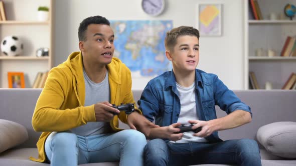 Emotional European and Afro-American Friends Playing Video Games, Leisure Time