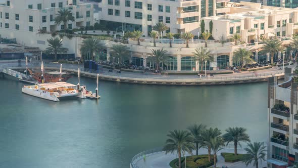 Luxury Dubai Marina Canal with Passing Boats and Promenade Timelapse Dubai United Arab Emirates