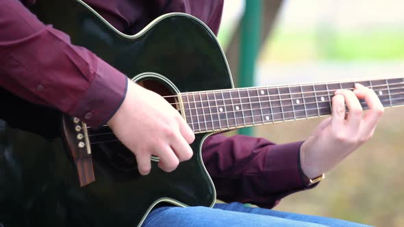 Man Playing Acoustic Guitar Outdoors